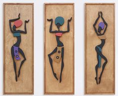 three wooden plaques with different shapes and designs on them, each depicting a woman's body