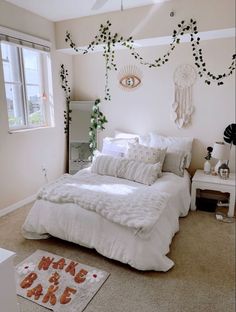 a white bed sitting in a bedroom next to a window with ivy growing on it