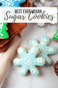 the best ever vegan sugar cookies with frosting on them and decorated in blue and green