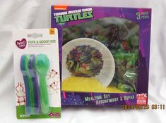 there are two plastic forks in the package and one is green with purple stripes on it