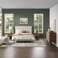 a bedroom with green walls and white furniture