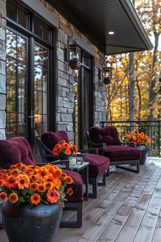 an outdoor deck with chairs and flowers on it