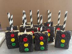 there are many pieces of cake that have been decorated to look like traffic lights with black frosting and candy canes