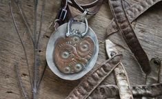 Petoskey Stone Pendant, Sterling Silver Necklace, Hand-stamped Copper Back, Leather Cord - Etsy Rustic Leather Stamped Jewelry, Artisan Hand Tooled Jewelry, Petoskey Stone, Stone Pendant, Sterling Silver Necklace, Leather Cord, Stone Pendants, Metal Jewelry, Sterling Silver Necklaces