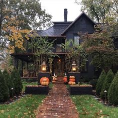 a house with pumpkins in the front yard