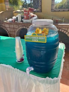 there is a large blue water jug on top of a table with other items around it