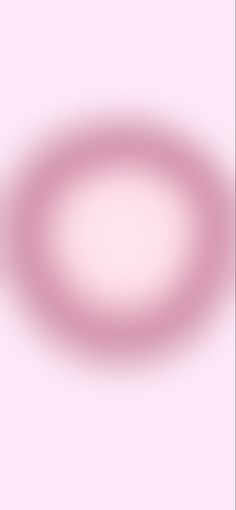 a blurry image of a circular object on a pink background