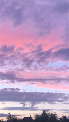 the sky is pink and purple with some clouds