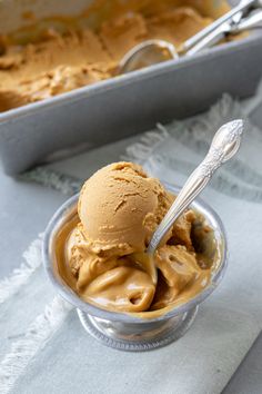 a bowl filled with ice cream next to a pan of cake