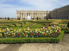 an elaborate garden in front of a large building