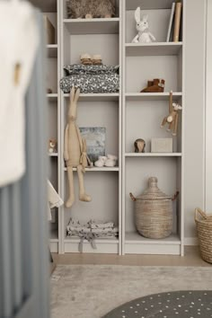 a white bookcase filled with stuffed animals and toys