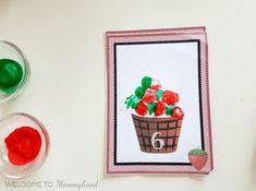 an image of a card with flowers in a basket on it next to two glasses