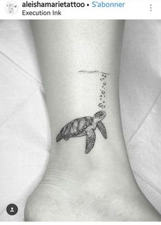 a small turtle tattoo on the ankle with bubbles coming out of its mouth and tail