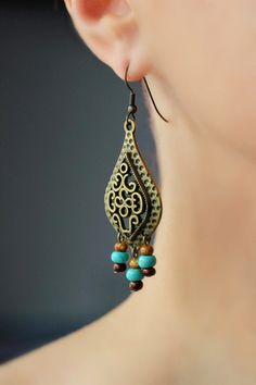 "These unique boho earrings was made of big drop shape antique brass charms, tiny czech glass \"picasso\" style blue,brown beads and antiqie brass earring hooks. Earring hooks are from nickel free and lead free metal. A wonderful jewelry for you or an unique gift for someone speacial! *The total lenght of earrings is about 67 mm including earring hooks. Other earrings of my shop you can see here: https://www.etsy.com/shop/NaTavelli?section_id=13757927 Thanks for visit." Bohemian Bronze Earrings With Dangling Beads, Bohemian Brass Beaded Drop Earrings, Bohemian Bronze Pierced Chandelier Earrings, Bronze Dangle Beaded Earrings For Jewelry Making, Bohemian Metal Beaded Pierced Earrings, Bohemian Bronze Chandelier Earrings For Pierced Ears, Bohemian Beaded Teardrop Dangle Earrings, Bohemian Bronze Jewelry With Dangling Beads, Handmade Bohemian Bronze Chandelier Earrings