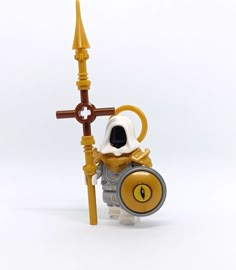 a lego figure with a cross on it's head and an eyeball in its mouth