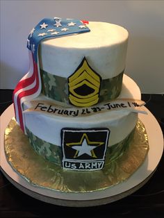 two tiered cake decorated with an army emblem and us flag on the bottom layer