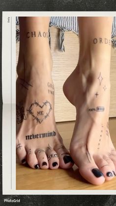 two people with tattoos on their feet standing next to each other