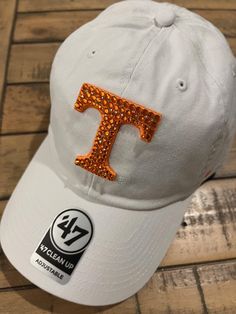 Tennessee Vols white '47 relaxed fit adjustable backstrap officially licensed hand embellished with orange and tiny clear Swarovski randomly placed for Max BLING.  Precise crystal placement and attention to detail. Please favorite my ETSY shop so your first to see all my new Volunteers hats and beanies and headbands. https://allabouttheblingcc.etsy.com Casual Snapback Baseball Cap With Rhinestones, Casual Adjustable Baseball Cap With Rhinestones, White Adjustable Hat With Rhinestones, White Adjustable Rhinestone Hats, Crystal Placement, Vols Football, Bling Hat, Tennessee Vols, Henderson Nv