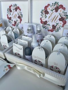 an assortment of personal care items in a white box with floral designs on the sides