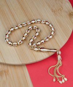 Gold Plated Sterling Silver Tasbih with Red and Black Zirconia Paved Oval Beads, Islamic Prayer Worry Beads. Each bead measures 7.50x8.50mm, and the total weight of the misbaha is 42.00 grams or 1.48 ounces.       The length of the tasbih is 10.50 inches or 26.65 cm. This beautifully crafted tasbih is made from high-quality 925 sterling silver and plated with 18K gold for a luxurious finish. Each bead is accented with red, blue, or turquoise enameled. The vibrant clear zirconia-paved beads add a touch of elegance and sophistication to your prayer ritual.       This tasbih is perfect for those seeking a meaningful and stylish addition to their spiritual practice. Comes with a gift box. Traditional Gold Beaded Rosary, Eid Gift Red Jewelry, Adjustable Gold Rosary Traditional Style, Adjustable Gold Traditional Rosary, Silver Tasbih, Worry Beads, Silver Gift Wrap, Enamel Beads, Islamic Prayer