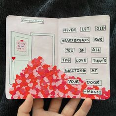 someone is holding up an open book with hearts on it and the pages have words written in them