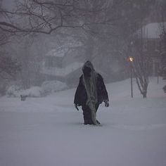 a person walking in the snow with an umbrella