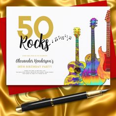 a 50th birthday party card with guitars on it and a pen sitting next to it