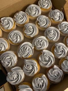 a box filled with cupcakes covered in frosting