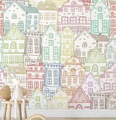 a child's room with colorful houses on the wall