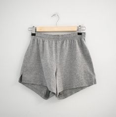 Description: 1990s gray cotton blend knit athletic shorts. Elastic waist. Side vent slits at hems.  Condition: In great condition, with no holes or stains. Laundered.  Designer: n/a Stated size: n/a  Measurements:  Circumference at hem: 21"  Inseam: 3"  Rise: 12"  Overall length: 11.5"  Waist: 24 - 30"  Hips: up to 37"  ---> If you need an order shipped by a particular date or shipped via a quicker method, please ask PRIOR to purchase to see if we can accommodate that request. Visit the rest of Black Swimsuit Cover Up, Sewing Tape Measure, Strapless Evening Gowns, Black Swimsuit, Circle Skirt, Corduroy Pants, Grey Cotton, Athletic Shorts, Stripe Sweater