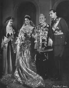 an old black and white photo of three people in formal dress