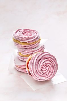 pink frosted donuts stacked on top of each other