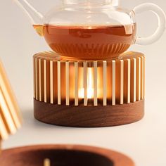 a tea pot sitting on top of a wooden stand