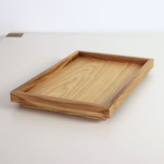 a wooden tray sitting on top of a white table