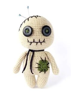 a crocheted doll with big eyes and a spider on it's back