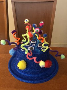 a blue cake with colorful decorations on it