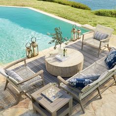 an outdoor living area with chairs, tables and a pool