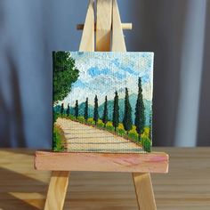 a small easel with a painting on it