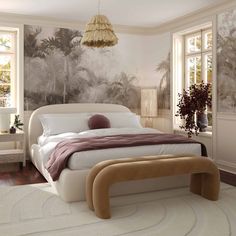 a bedroom with a large bed in the middle and wallpaper on the other side