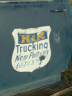 an old truck with the word h r trucking painted on it's side