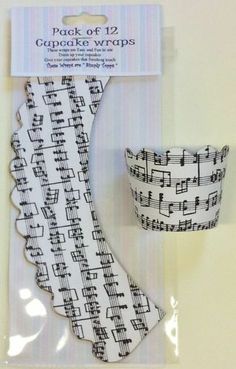 a pair of black and white musical notes on the side of a paper cupcake wrapper