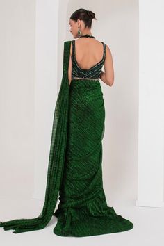 Emerald green pre-draped saree with all over metallic detailing. Paired with a sleeveless halter neck blouse with dangling halo nalki embellishments and a hand embellished belt. - Aza Fashions Green Blouse Piece For Evening With Traditional Drape, Green Silk Pre-draped Saree, Green Pre-draped Saree For Reception, Green Draped Saree With Unstitched Blouse, Green Sleeveless Pre-draped Saree For Festive Season, Festive Green Pre-draped Saree, Green Silk Pre-draped Saree For Evening, Fitted Green Pre-draped Saree In Traditional Drape, Green Fitted Pre-draped Saree Traditional Drape