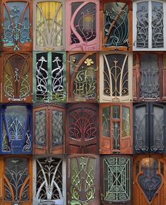 an assortment of wooden doors with decorative designs on the front and side panels, all painted different colors