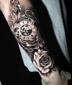 a man's arm with a clock and roses on it