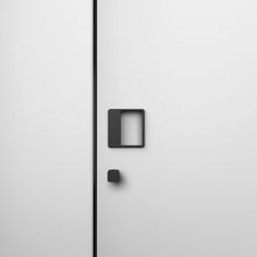 a white door with a black handle and square knob on the left side of it