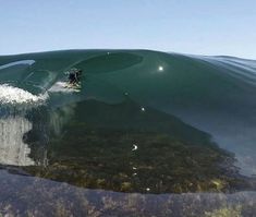 a man riding a wave on top of a surfboard