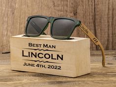 a wooden box with sunglasses on it and the words best man lincoln engraved in black