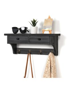 a wooden shelf with two drawers and sunglasses on it