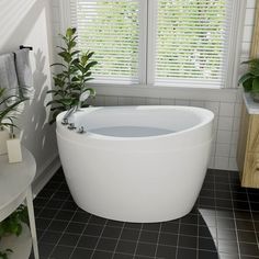 a white bath tub sitting next to a window