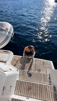 a man sitting on the back of a boat